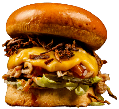 A burger with chicken, avocado, spinach and mayo